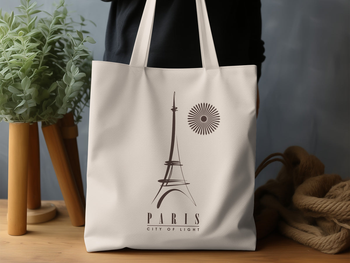 Paris City of Light Tote Bag in a lifestyle setting, highlighting the refined minimalist travel-poster design and warm monochrome artwork.
