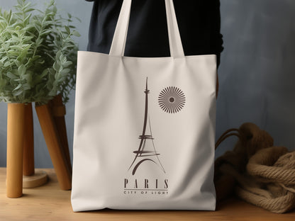Paris City of Light Tote Bag in a lifestyle setting, highlighting the refined minimalist travel-poster design and warm monochrome artwork.
