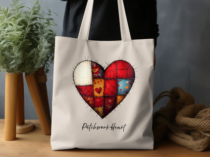 Canvas Patchwork Heart Tote Bag featuring red, burgundy, cream, gold and blue panels, a small red heart on a gold panel and stitch-style detailing.
