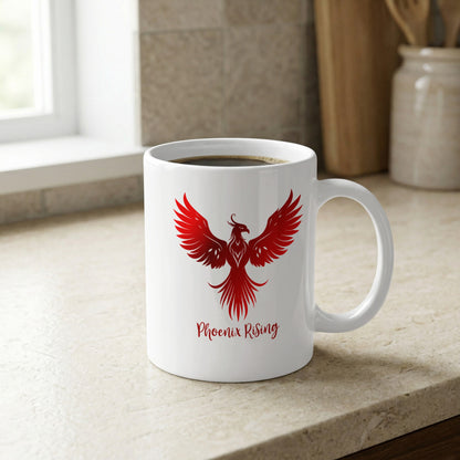11oz ceramic Phoenix Rising Mug with a red phoenix rising upward, fine feather detailing and a clean white background.