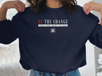 Video of long sleeve crew neck sweatshirt in soft fabric, featuring inspirational Be the Change message design.