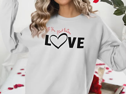All You Need Is Love sweatshirt chest graphic with bold Love black typography and heart-shaped letter detail in centre.
