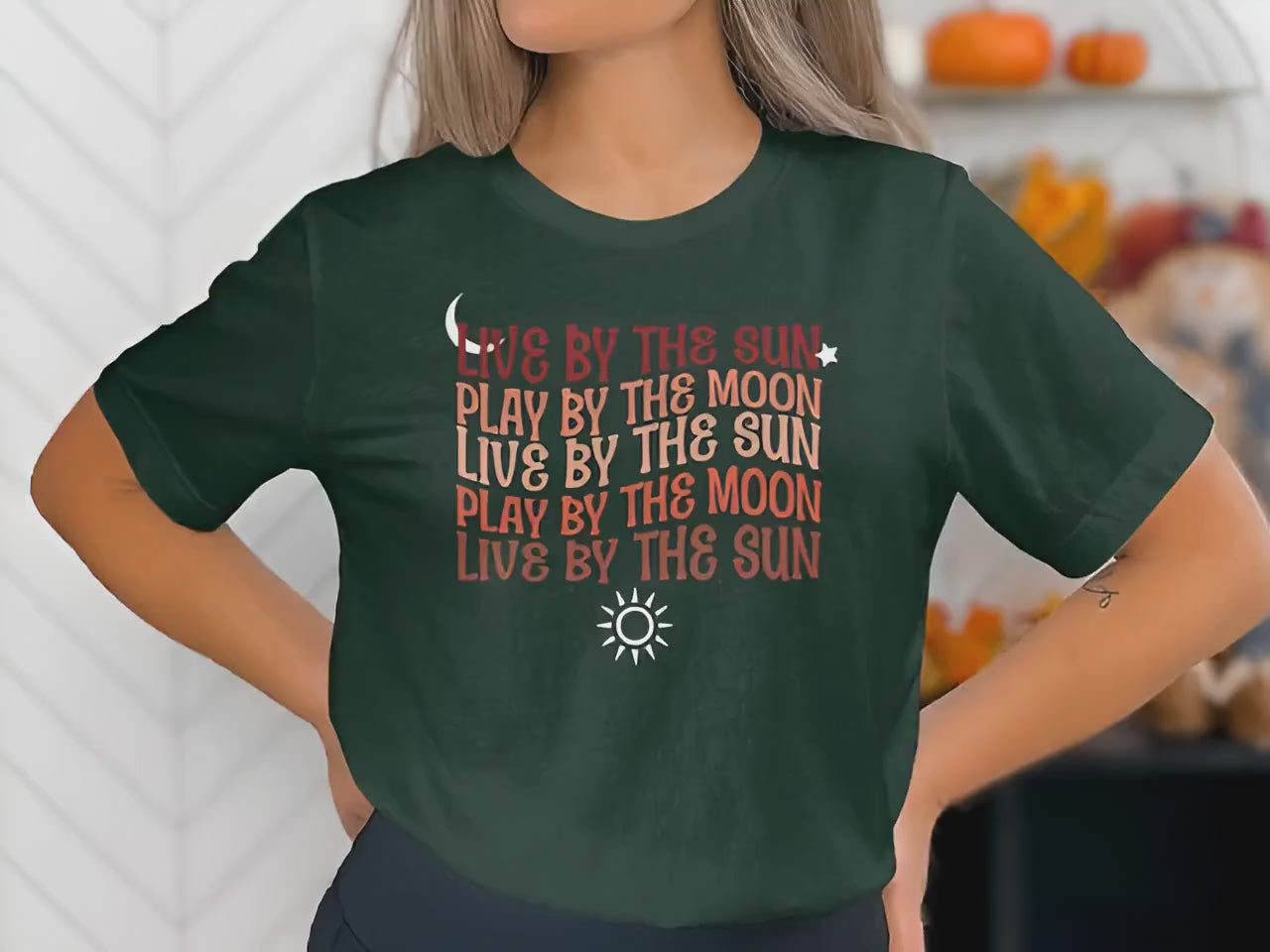 Live By The Sun Play By The Moon t-shirt showing chest mantra typography in warm retro script with sun and moon details.