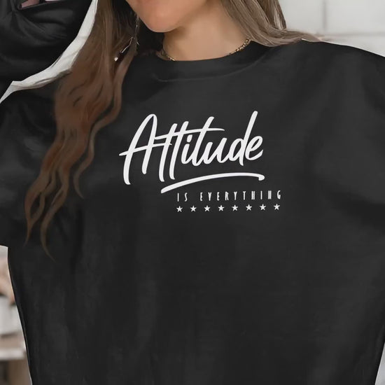 video of long sleeve crew neck sweatshirt in soft fabric, featuring bold Attitude Is Everything statement design.