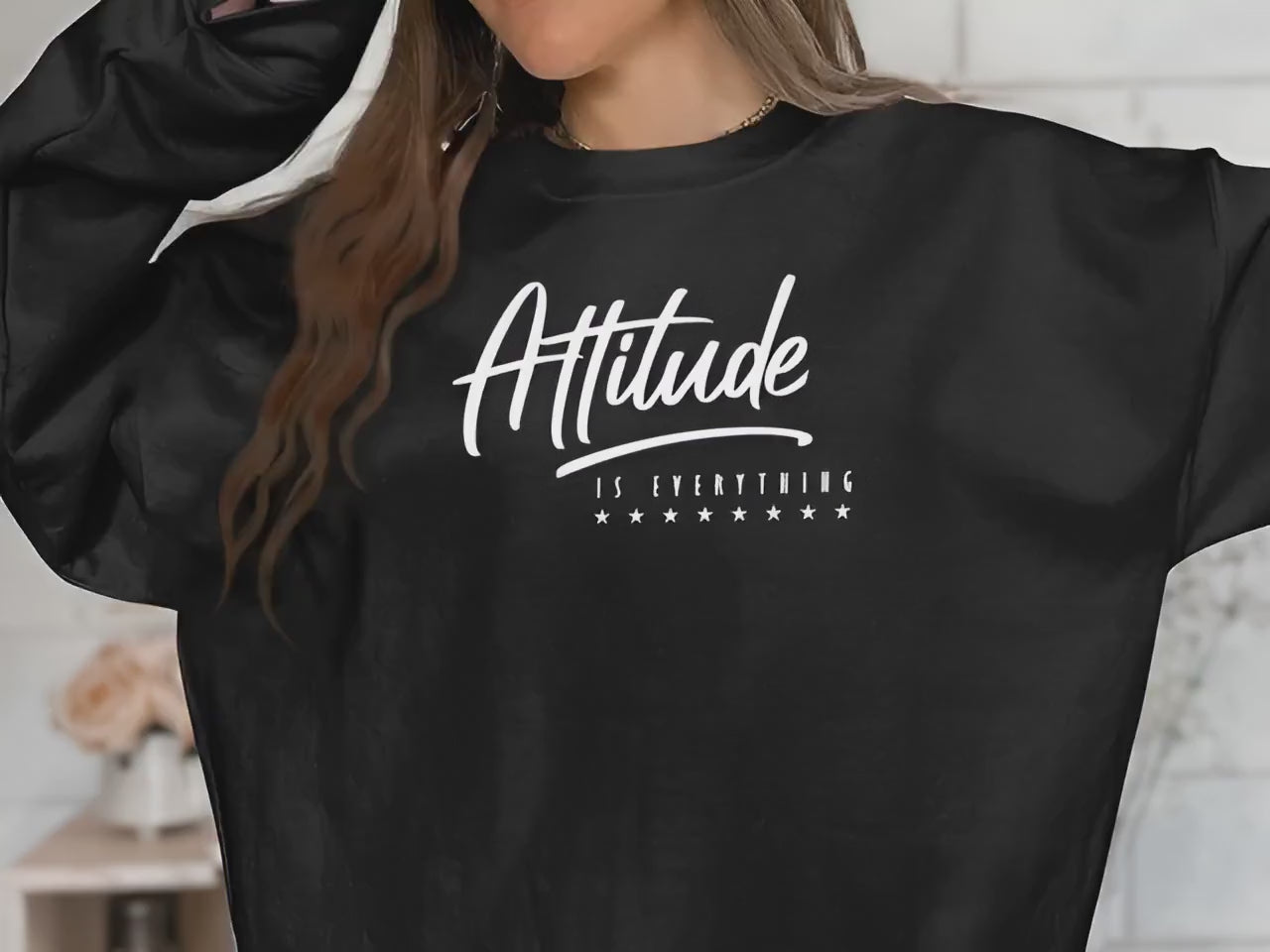 video of long sleeve crew neck sweatshirt in soft fabric, featuring bold Attitude Is Everything statement design.