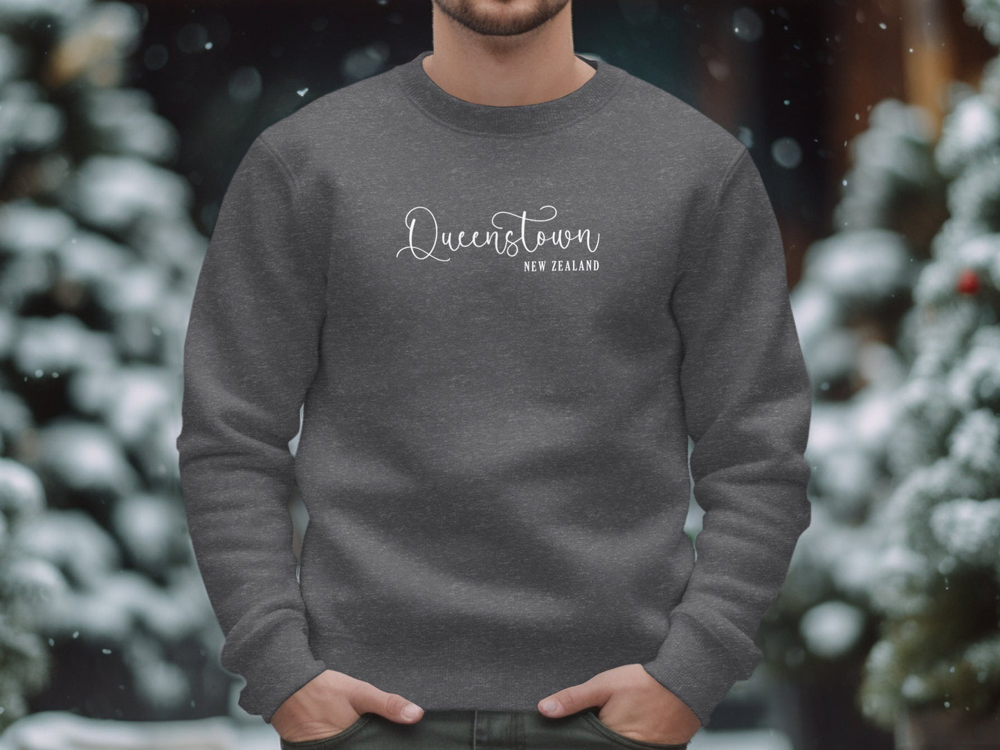 Dark heather Queenstown Sweatshirt with flowing Queenstown script and spaced New Zealand destination white text subtitle.