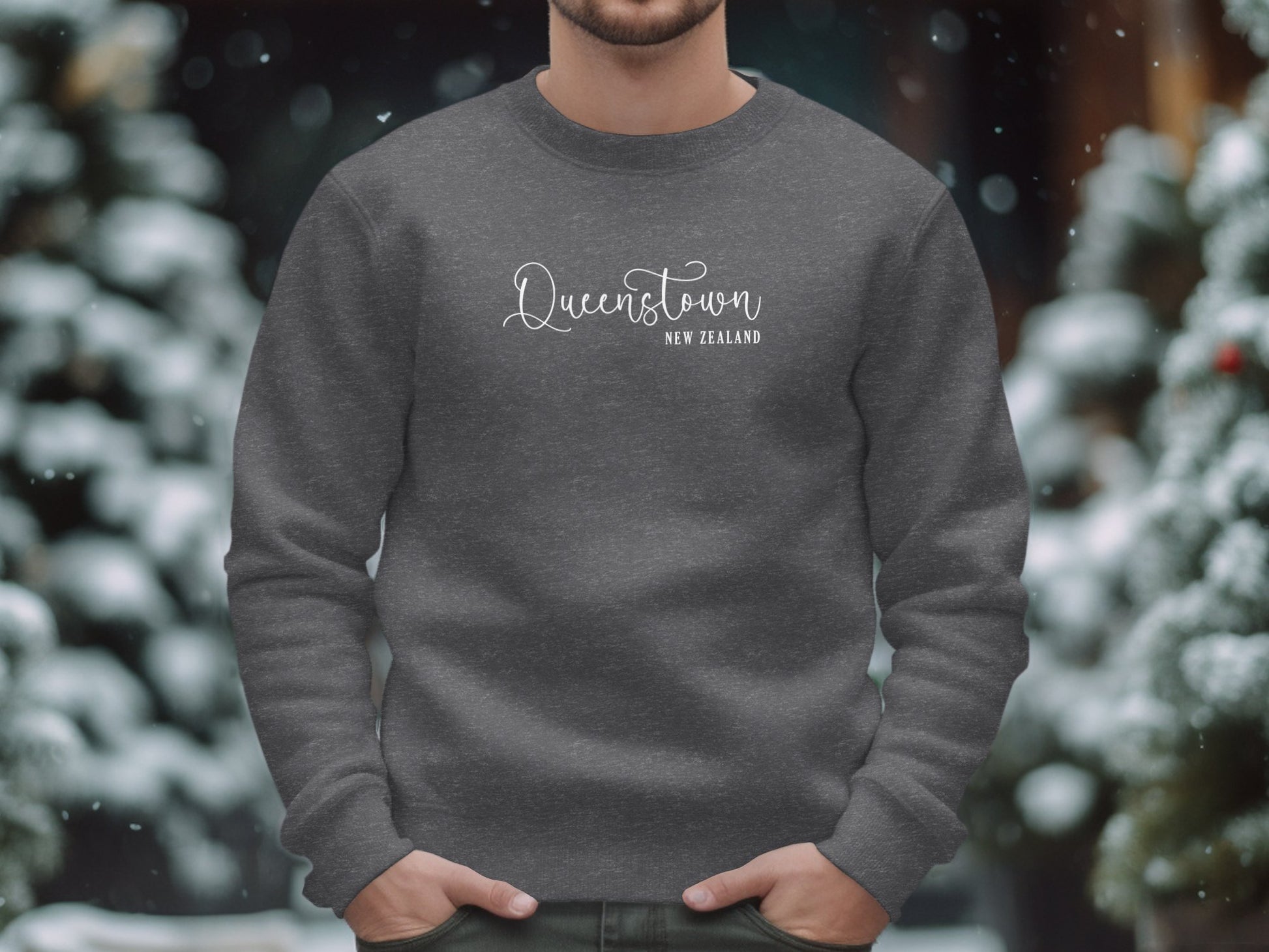 Dark heather Queenstown Sweatshirt with flowing Queenstown script and spaced New Zealand destination white text subtitle.