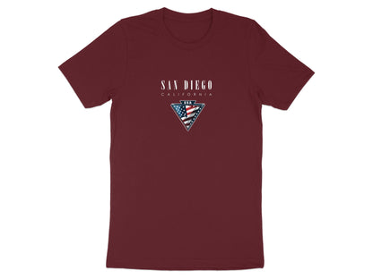 Maroon San Diego t‑shirt featuring white serif San Diego lettering and a vivid USA flag badge framed in a metallic‑style triangle.