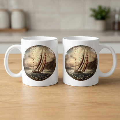11oz white mugs showing front and back with vintage yacht artwork, circular badge framing and SAN FRANCISCO / 1932 lettering.