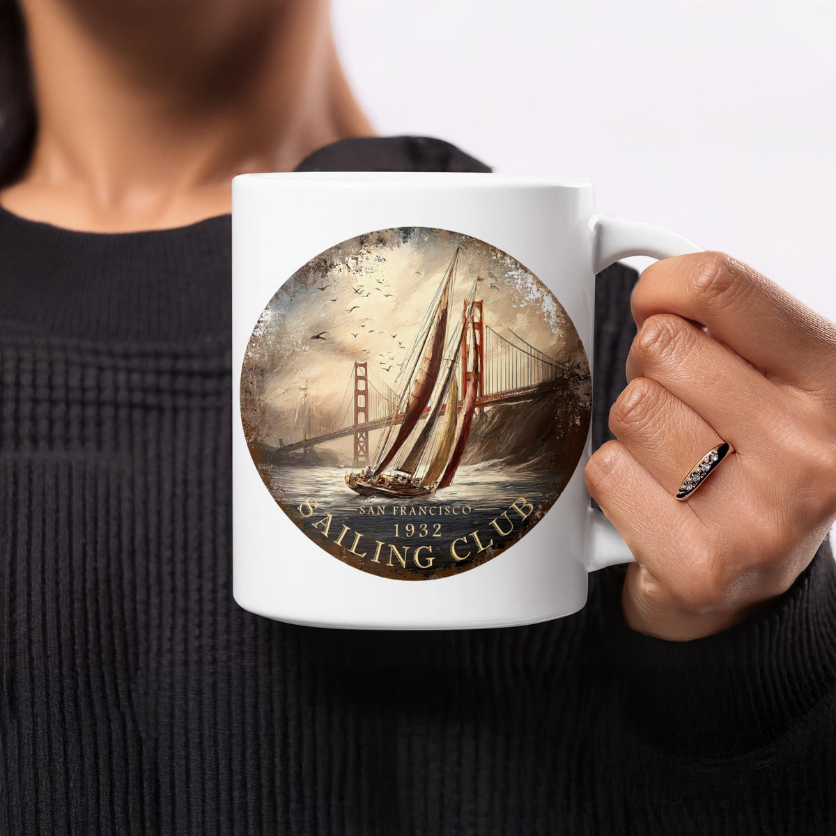 11oz San Francisco Sailing Club ceramic mug held in hand, showing warm cream sails, terracotta-red artwork and vintage maritime detailing.