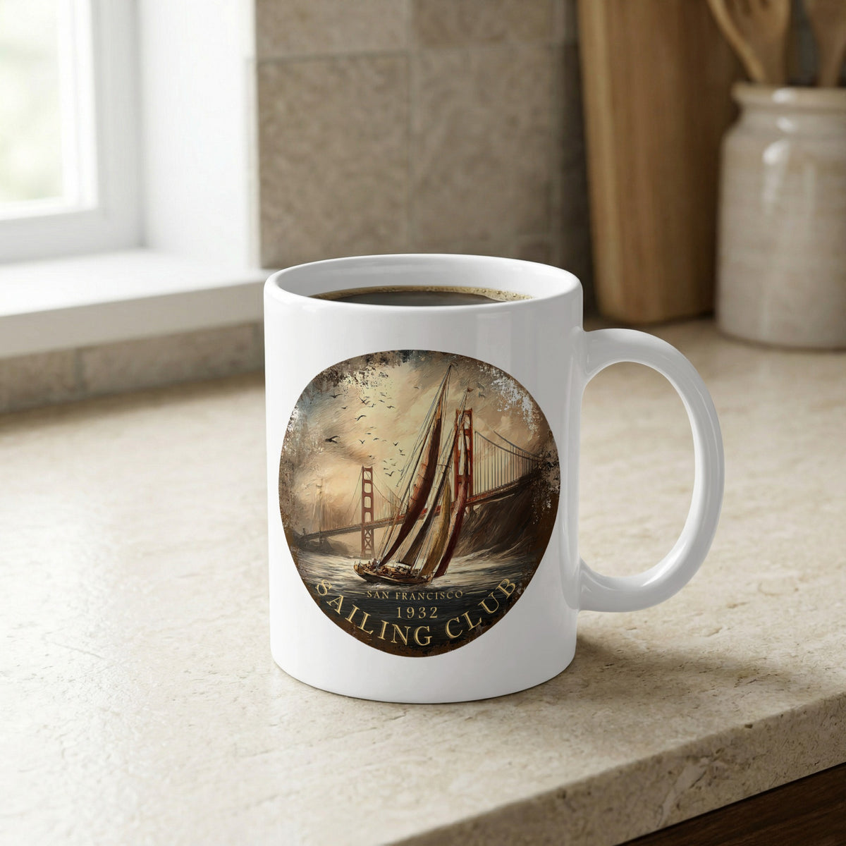 White 11oz ceramic mug on a kitchen bench with a sailing yacht, hazy Golden Gate Bridge and distressed circular artwork.
