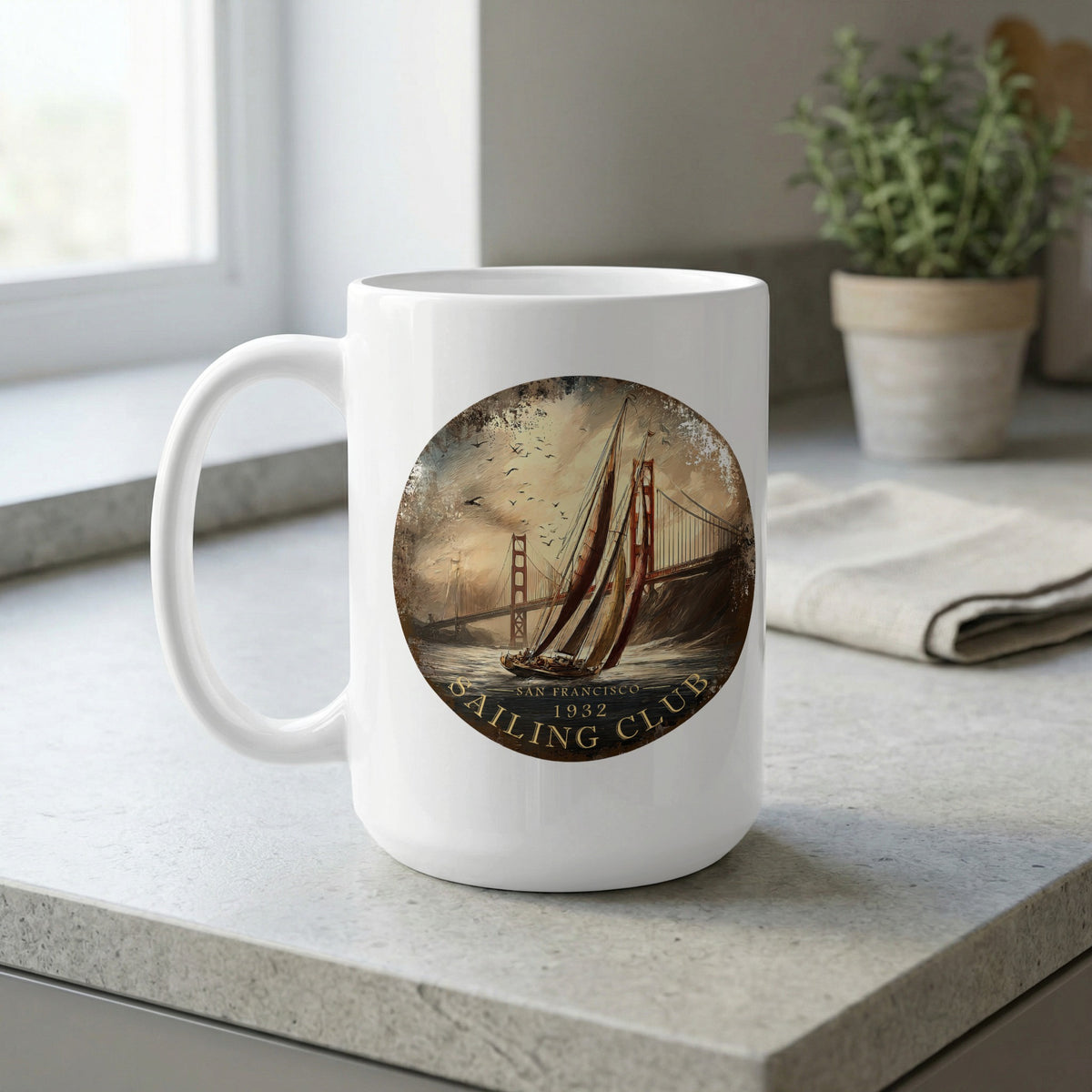 White 15oz ceramic mug on a kitchen bench featuring terracotta sails, a yacht on choppy water and birds in the hazy sky with 'Sailing Club' curved lettering.