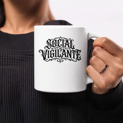 Social Vigilante Mug side view displaying the ornate blackletter artwork and decorative border on white ceramic.