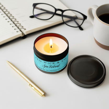 Spa retreat scented tin candle 4oz lit with surrounding decor creating a peaceful and rejuvenating home setting.
