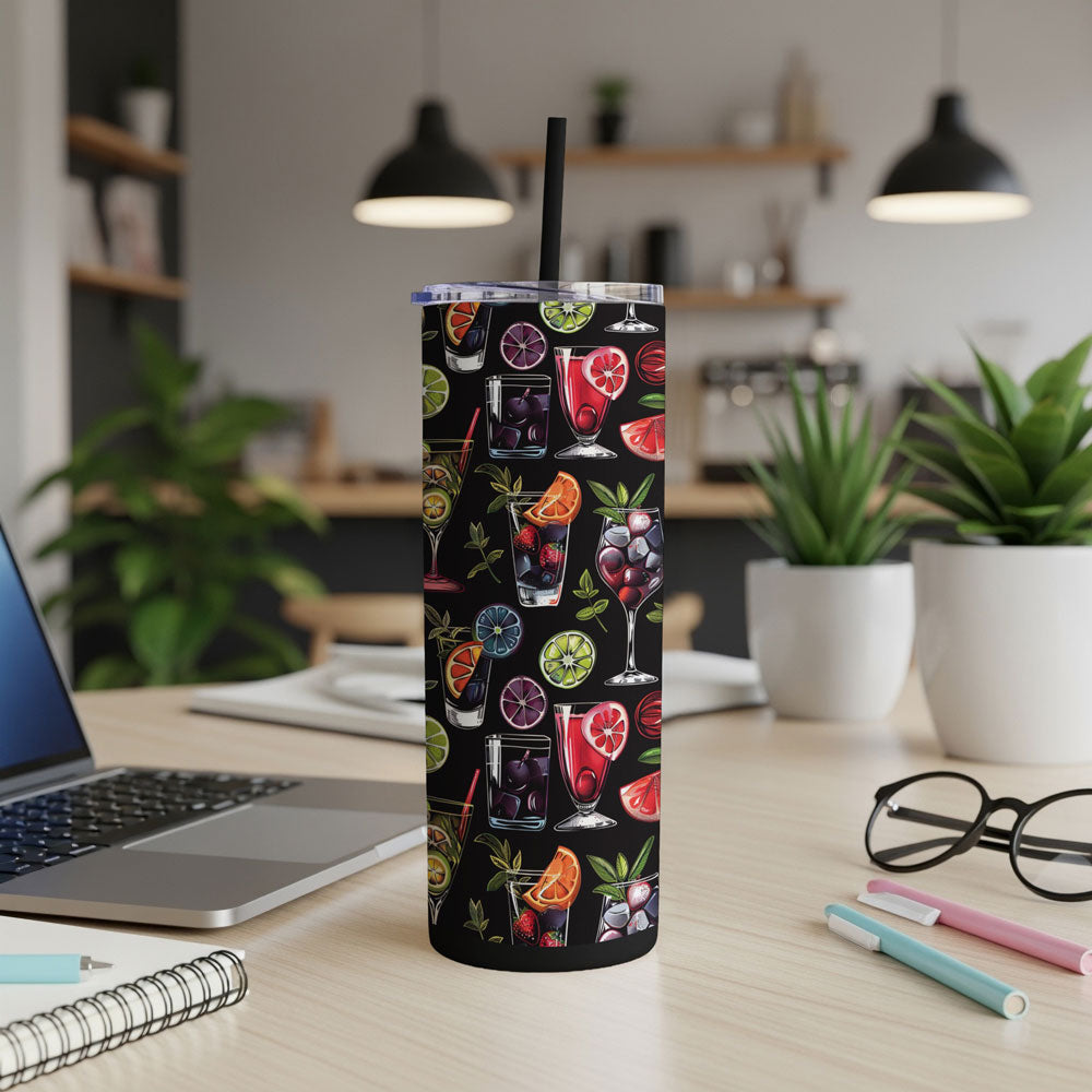 Black stainless steel 20oz skinny tumbler with colourful cocktail and citrus fruit print on an office desk.