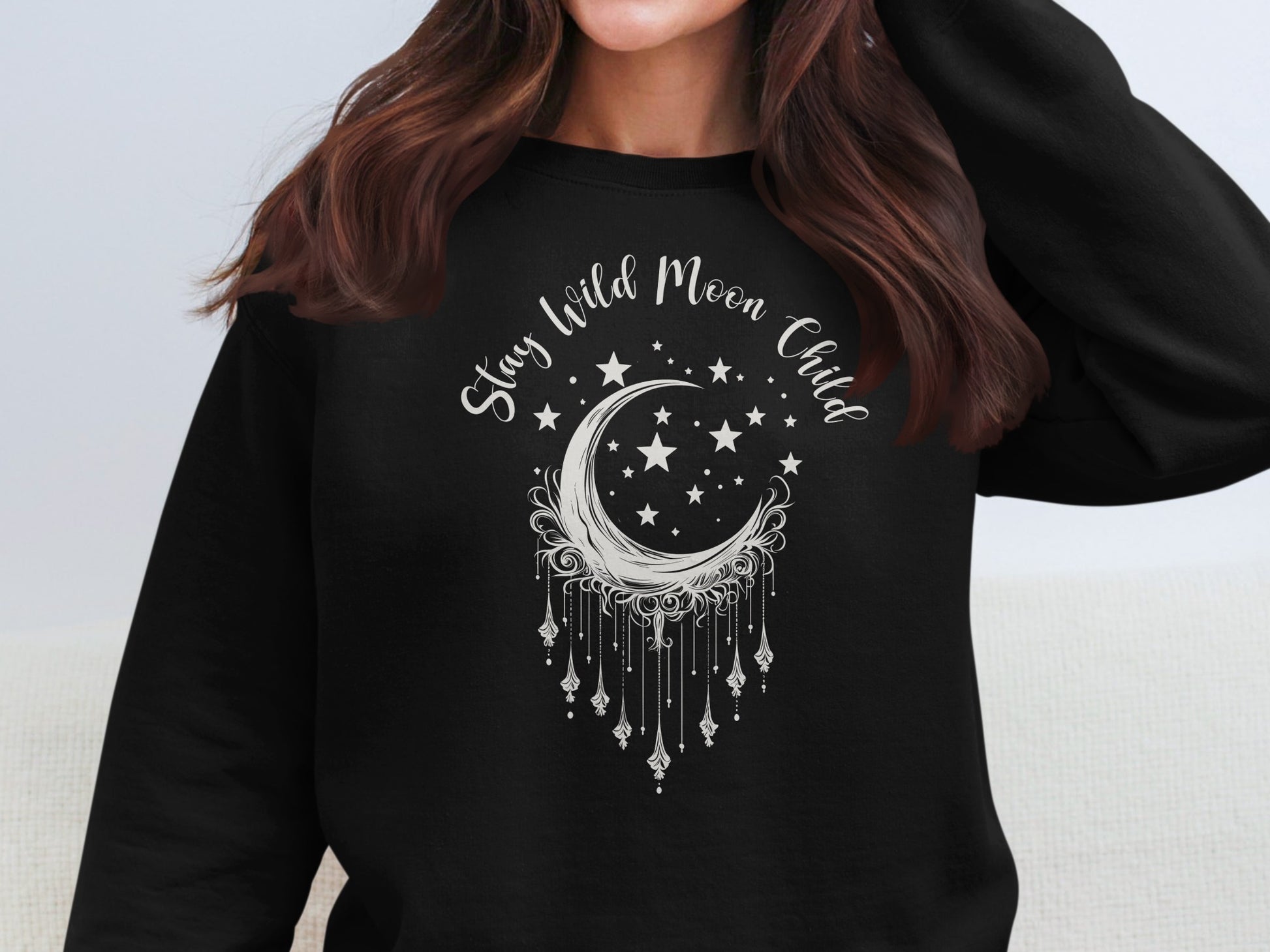 Stay Wild Moon Child black sweatshirt with celestial graphic, boho-inspired, soft cotton blend.