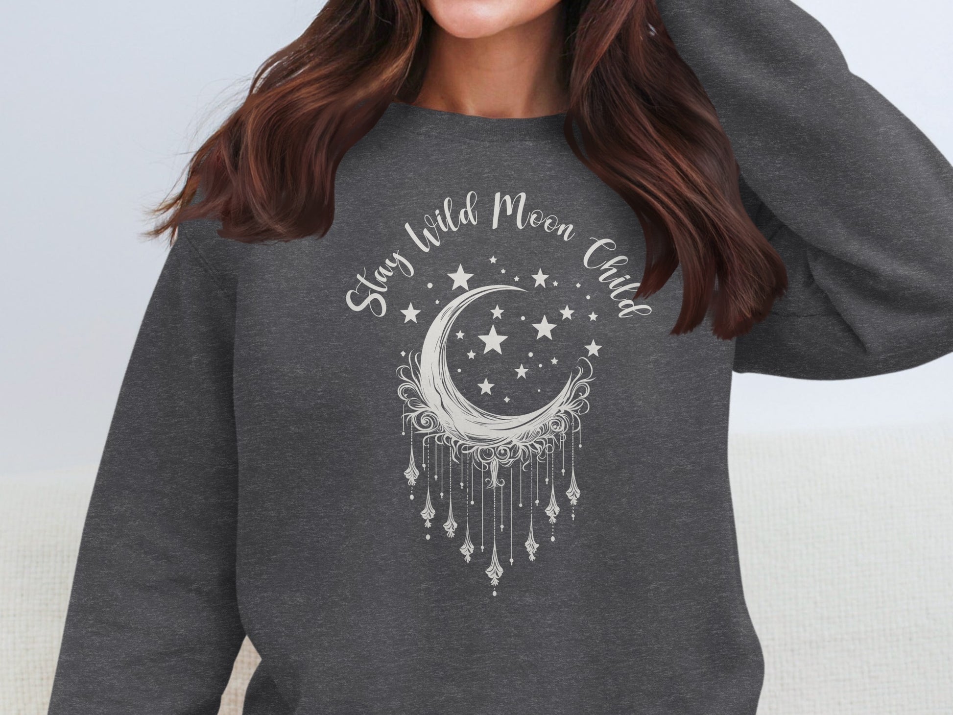 Dark heather Stay Wild Moon Child sweatshirt with mystical moon design, cozy fleece feel, and relaxed fit.
