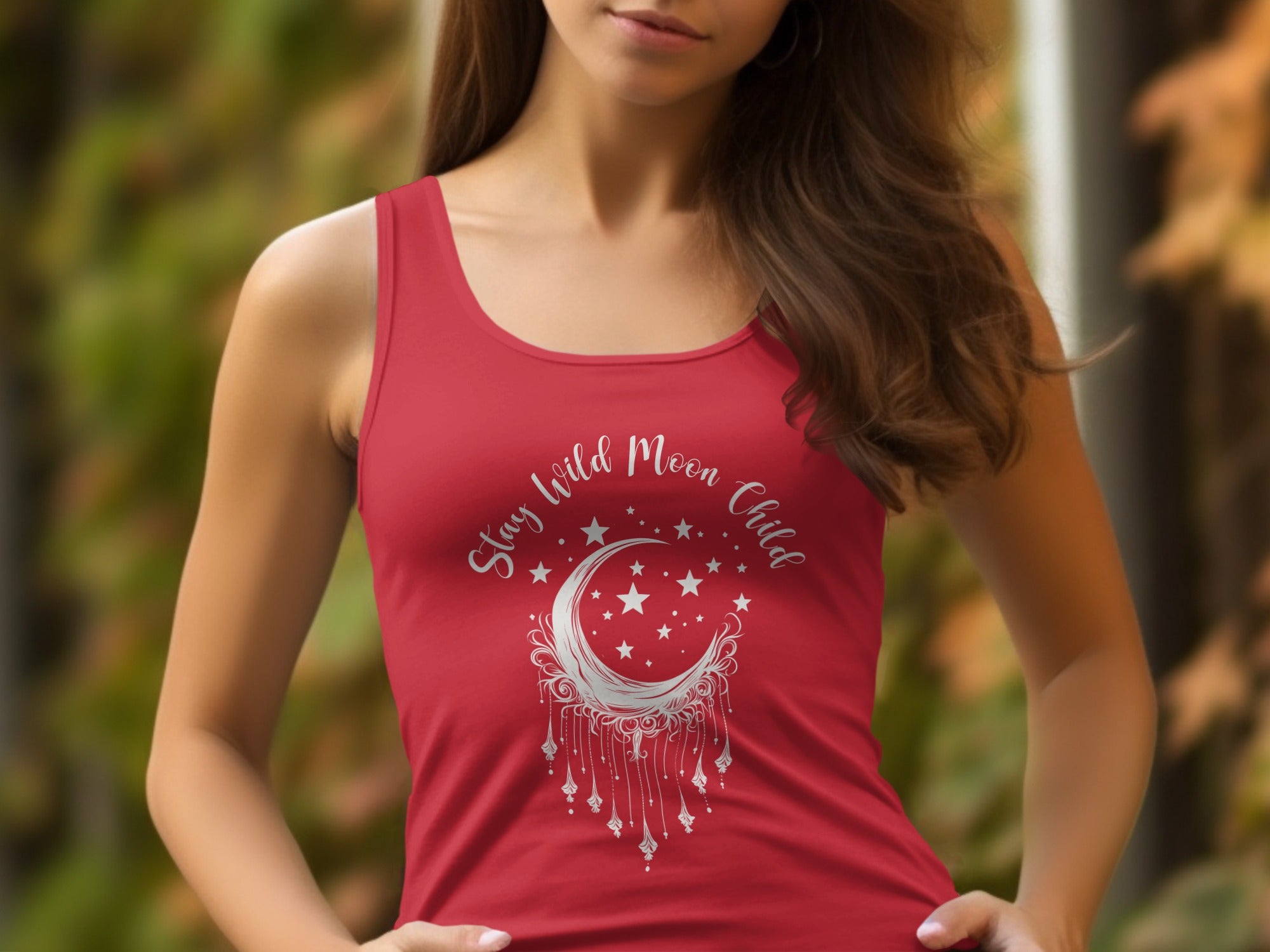 Red Stay Wild Moon Child tank top featuring detailed moon-and-stars artwork with flowing dreamcatcher-style fringe.