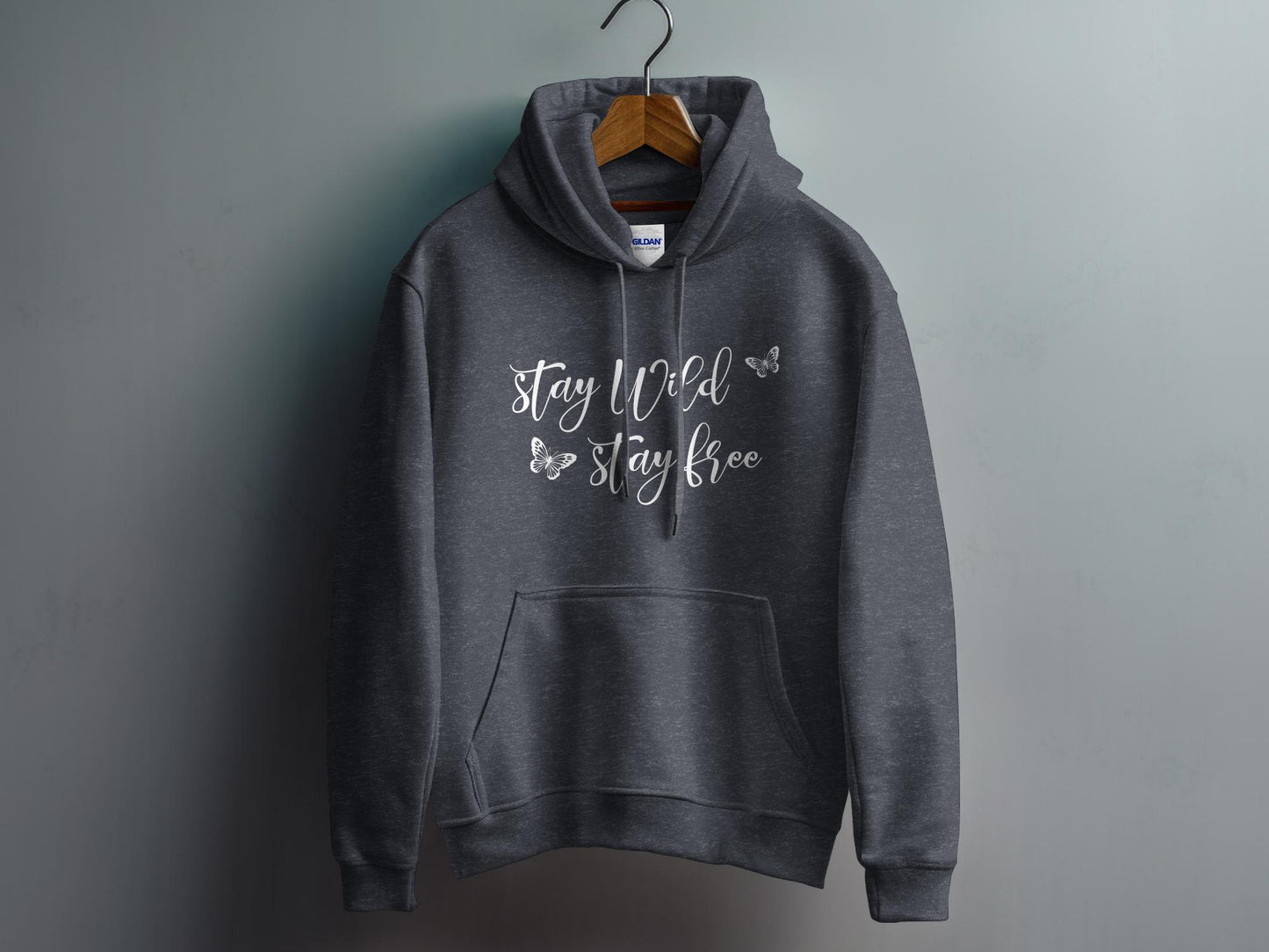 Dark Heather Grey Stay Wild Stay Free Hoodie featuring free-spirited Stay Wild script lettering with delicate butterfly outlines.
