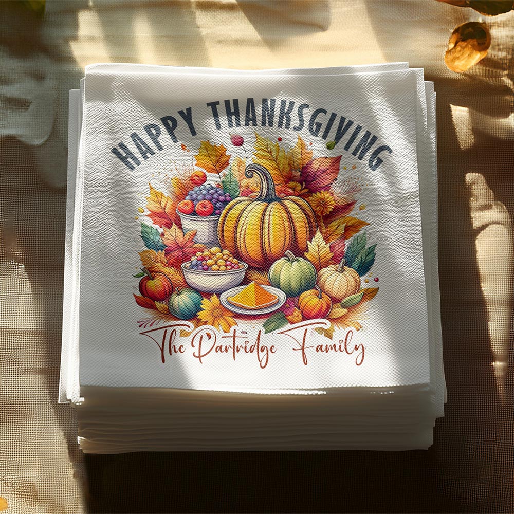Personalised Happy Thanksgiving cocktail napkins with harvest pumpkin print styled on a sunlit table.
