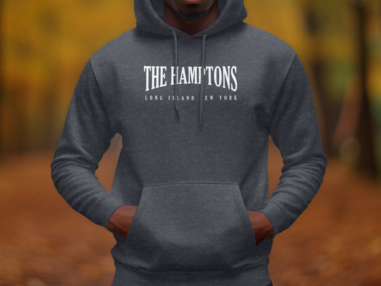 Dark heather grey Hamptons hoodie with refined white typographic chest print and minimalist coastal destination design.