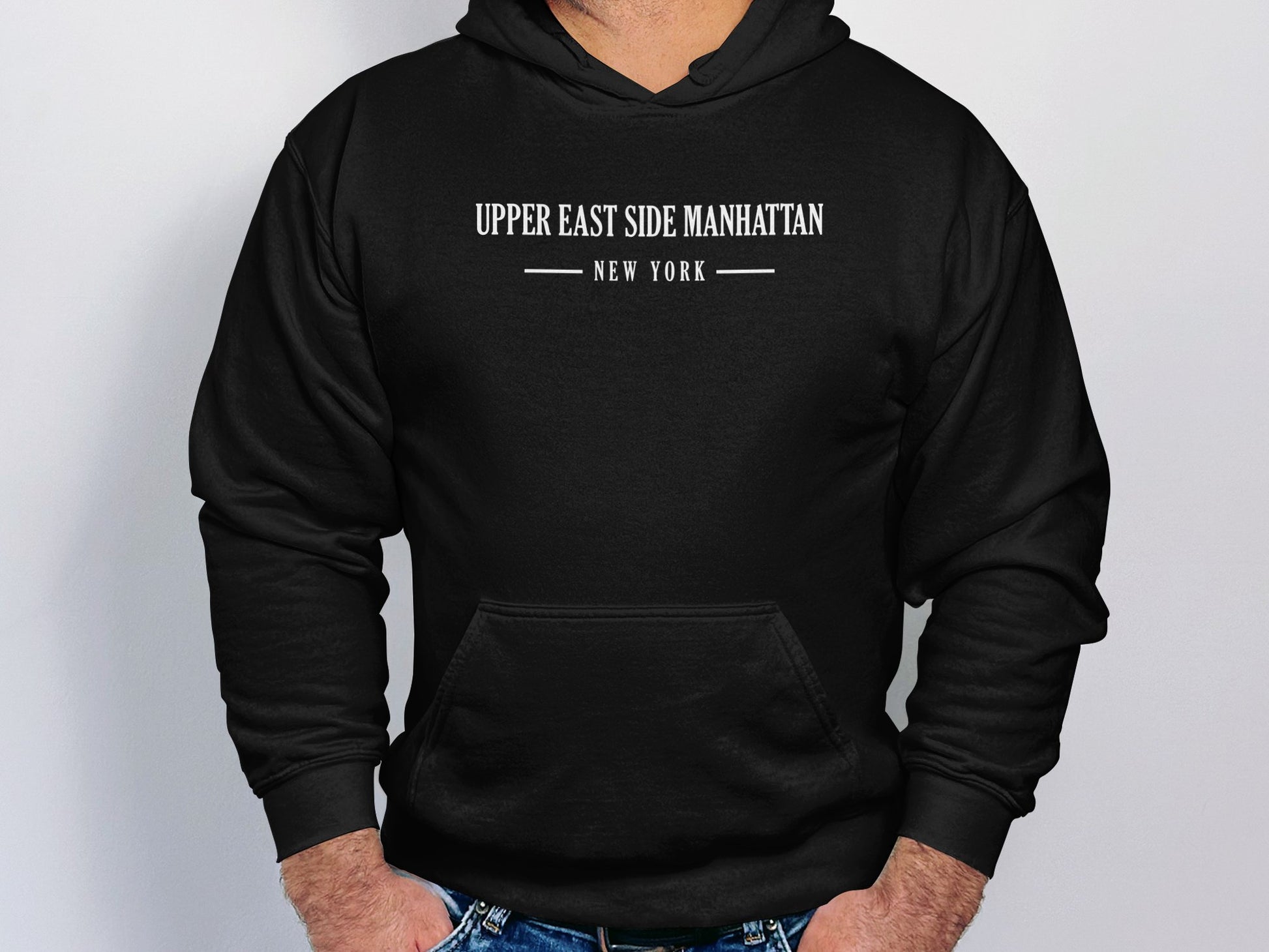 Black Upper East Side Manhattan Hoodie with bold graphic design, unisex pullover fit, & long sleeves for versatile styling