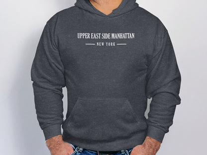 Dark heather grey Upper East Side Manhattan hoodie featuring monochrome serif text and minimalist urban chest layout.