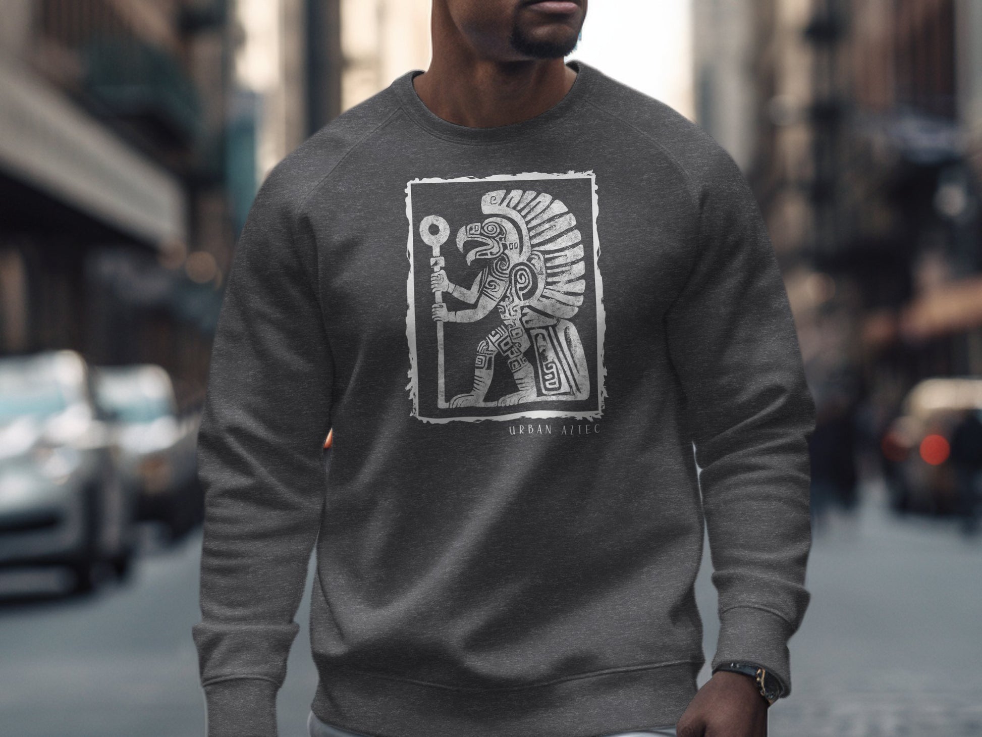 Dark heather Urban Aztec Sweatshirt Edition 3 with full-body Aztec warrior, feathered headdress, and glyph detailing at centre chest.
