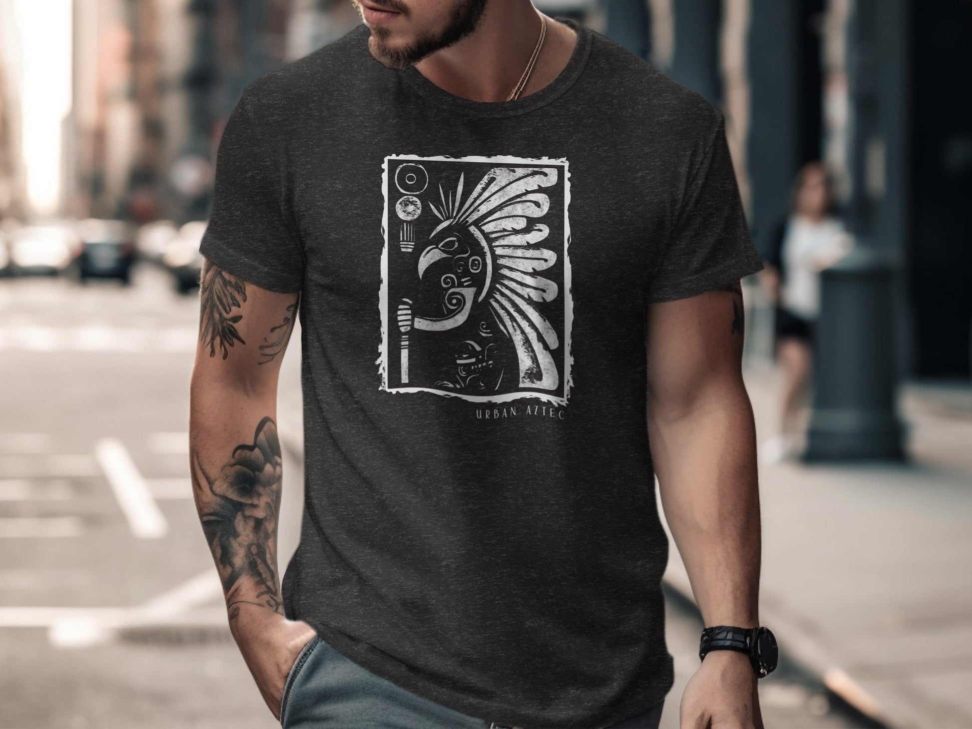 Dark heather grey Urban Aztec Edition 2 t-shirt with framed warrior chief artwork featuring headdress and torch motif.