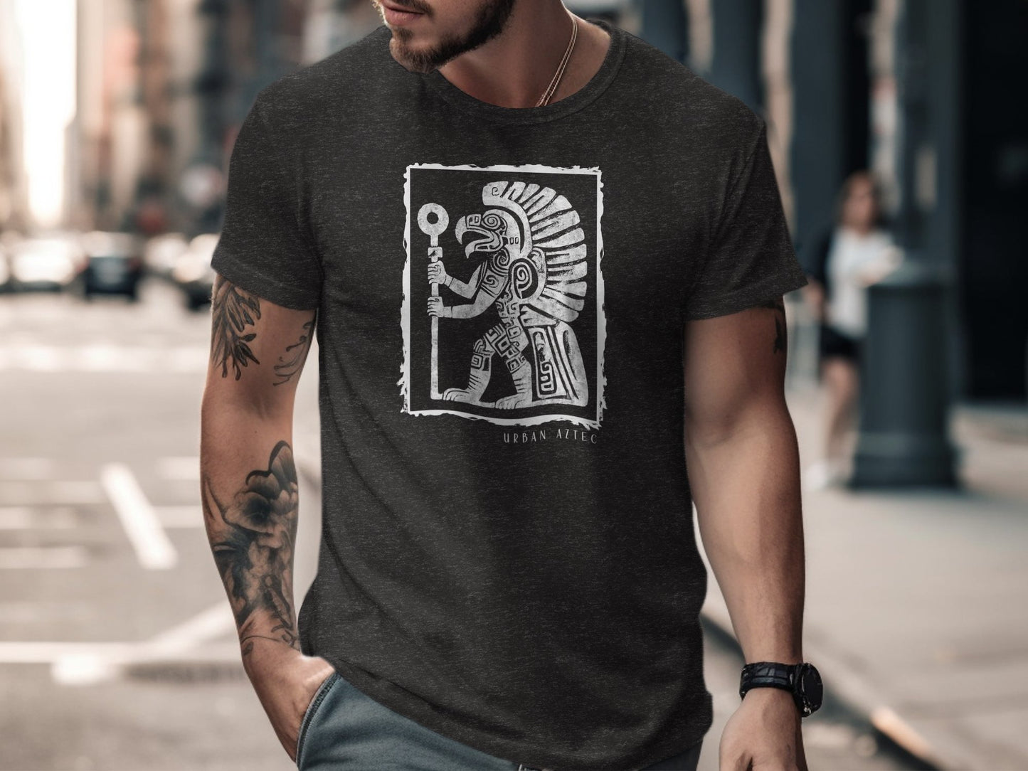 Dark heather grey Edition 3 t-shirt showing dynamic Aztec deity artwork with geometric armour inside a distressed frame.
