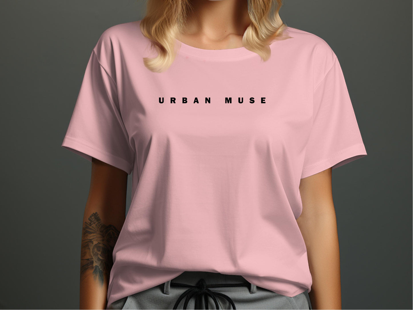 Pink Urban Muse T-Shirt showcasing the clean, minimalist widely spaced black font positioned across the front.