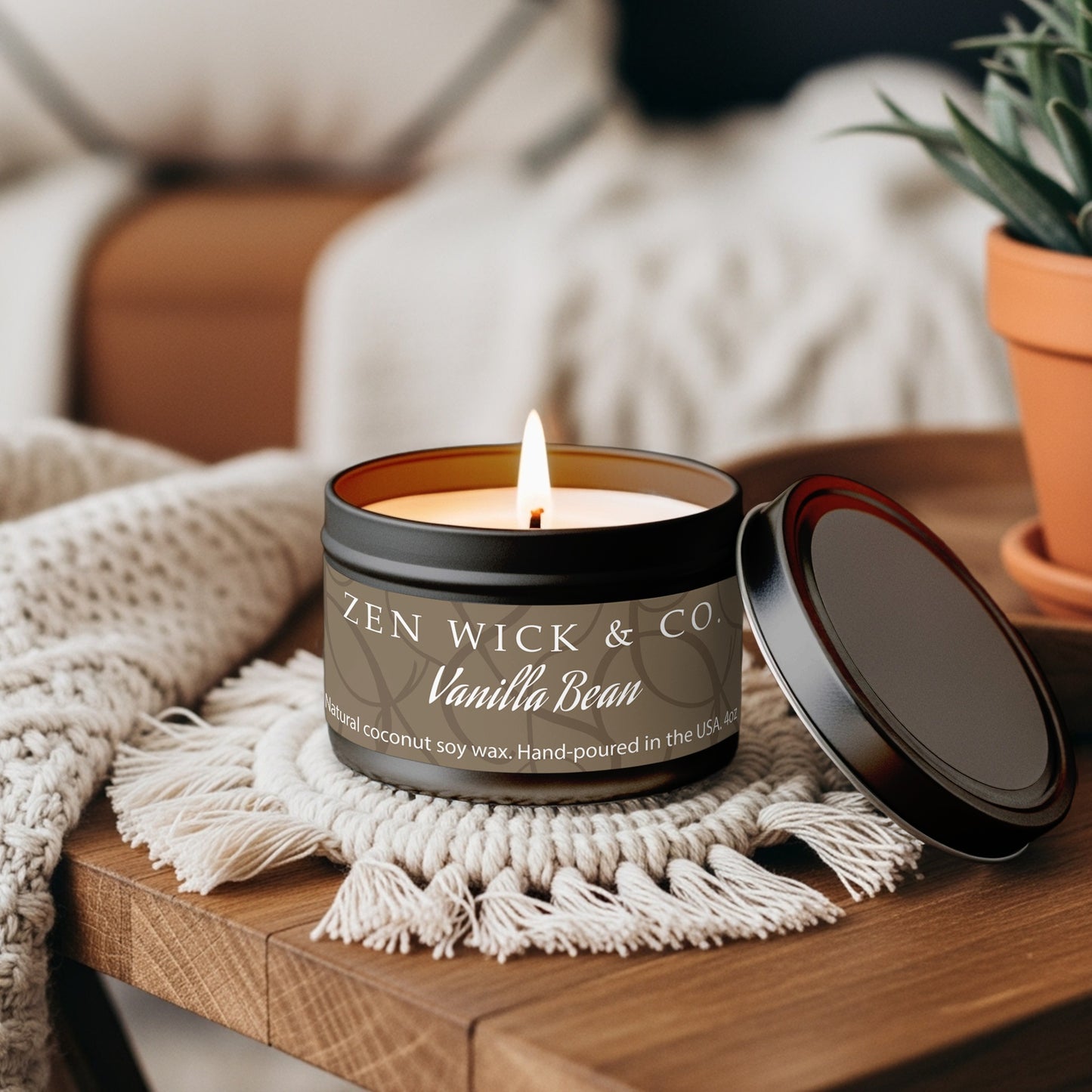 Vanilla bean scented tin candle 4oz styled on coffee table adding a soft warm touch to everyday home decor.