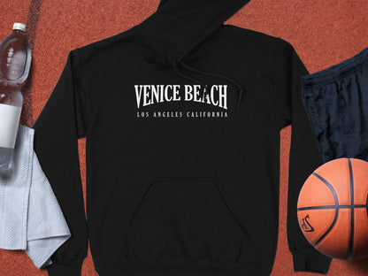 Black Venice Beach Hoodie with graphic design, long sleeves, relaxed unisex fit, and front pouch pocket