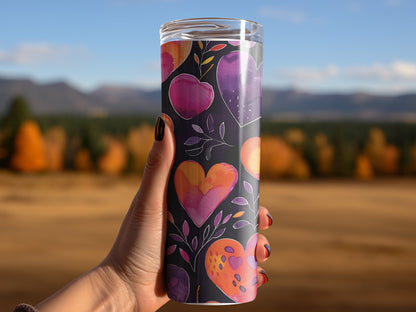 Woman using vibrant hearts tumbler, insulated 20oz tumbler with playful heart patterns and sleek stainless steel finish
