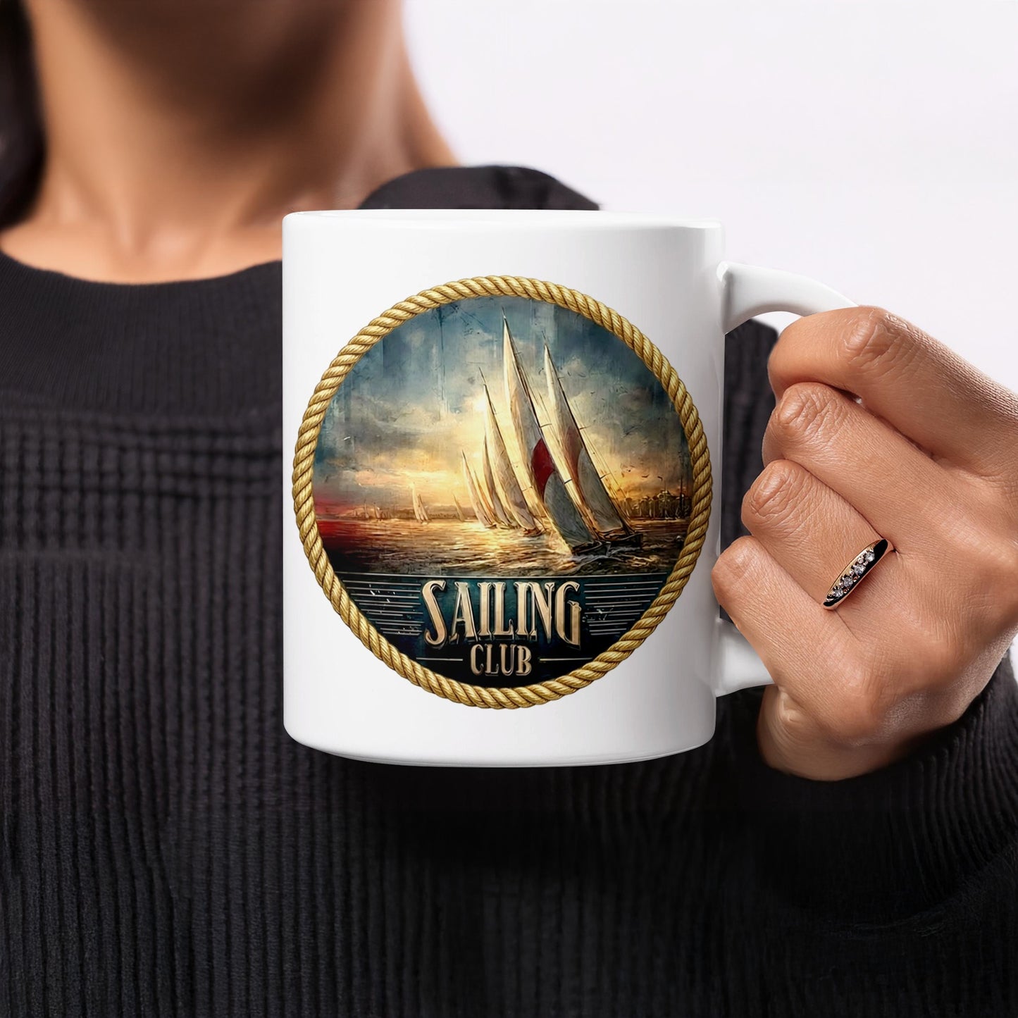 Woman holding Vintage Sailing Club 11oz mug featuring rope-framed maritime emblem and sailing yachts.
