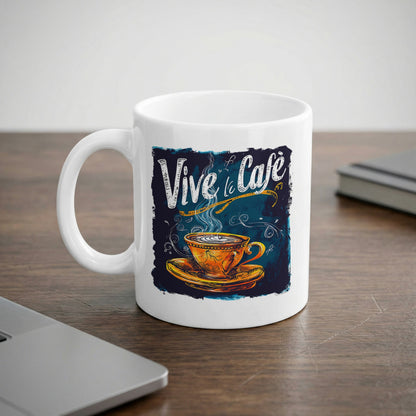 11oz Vive le Cafe Chalk Art Mug displayed on an office desk, featuring navy and teal artwork with white lettering.