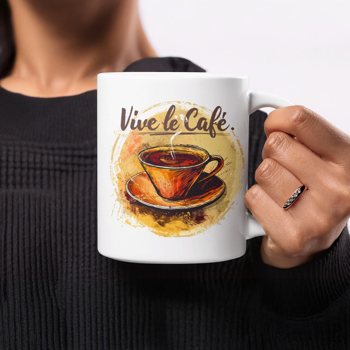 11oz Vive le Cafe Watercolour Mug held in hand, showing the warm amber cup illustration, soft painted wash and brown script.