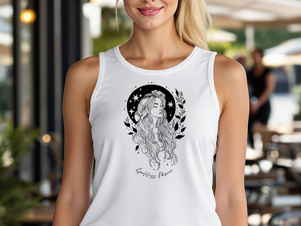 Woman wearing white sleeveless tank top with black Goddess Power celestial graphic featuring feminine line art, stars, and botanical details.