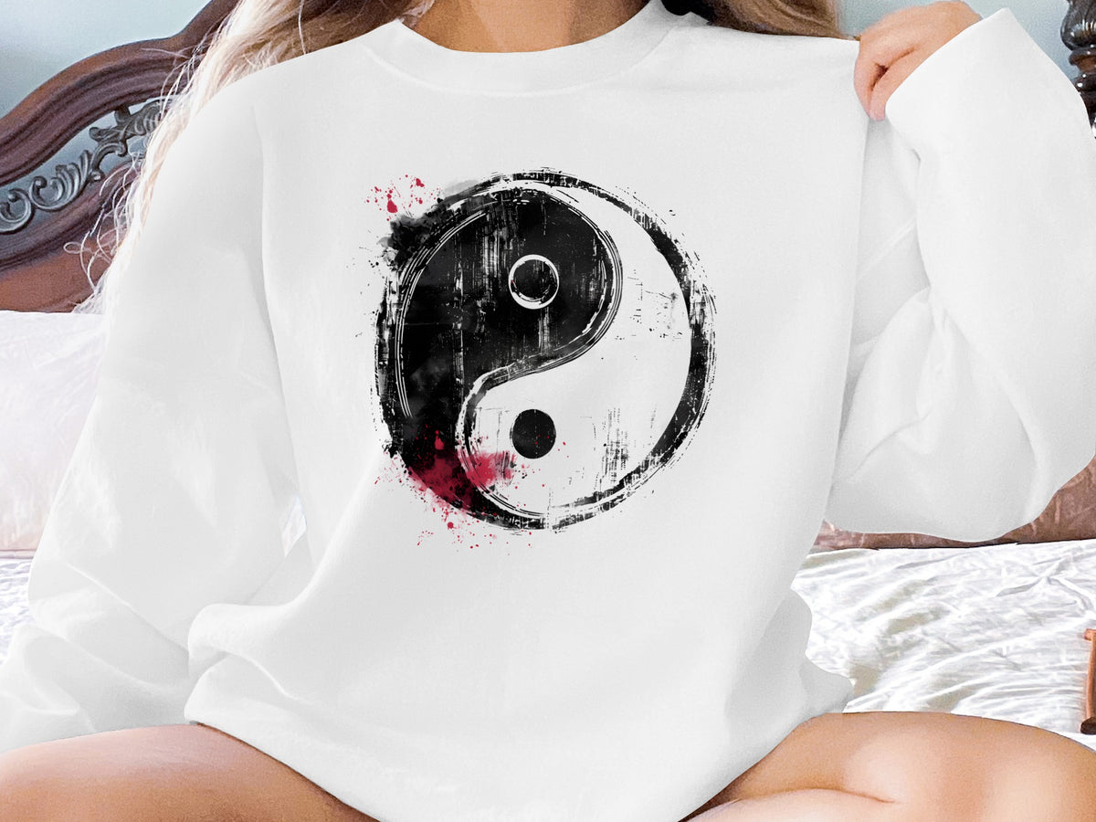 White Yin Yang crewneck sweatshirt with spiritual energy chest graphic and bold contrast design with red painterly accents.