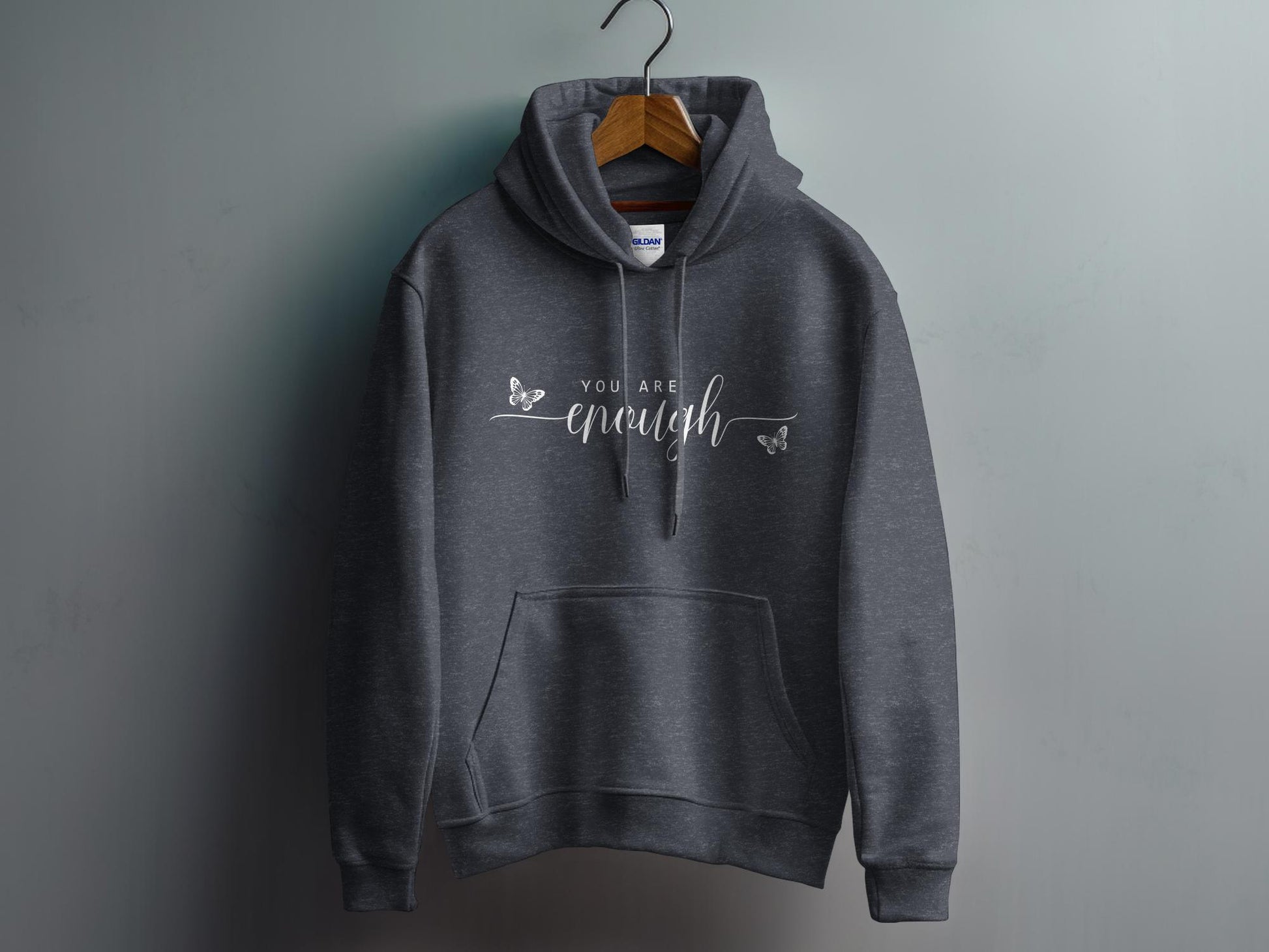 Dark Heather Grey You Are Enough Hoodie showcasing minimalist affirmation text with oversized handwritten-style enough script.