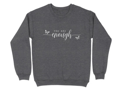 Dark Heather You Are Enough sweatshirt with layered white typography combining spaced caps and oversized calligraphic lettering.