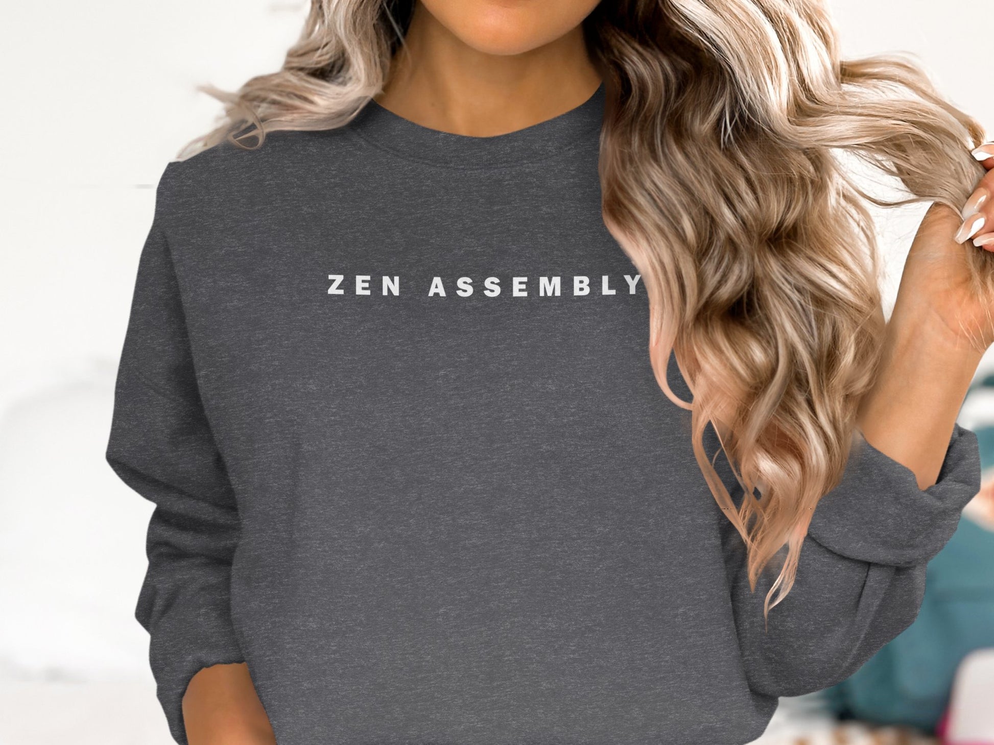 Dark Heather Zen Assembly sweatshirt featuring minimalist typographic artwork with spaced white capital lettering.
